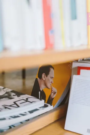 Bookshelf With A Thoughtful Man