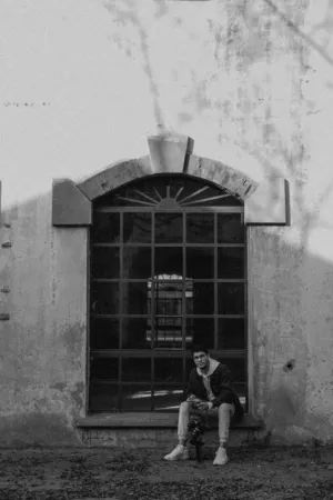Man Sitting By Window