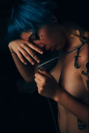 Blue-Haired Individual With Flower