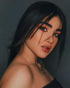 Portrait Of A Woman With Dark Hair And Bold Makeup