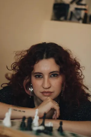 Curly-Haired Woman With Chessboard