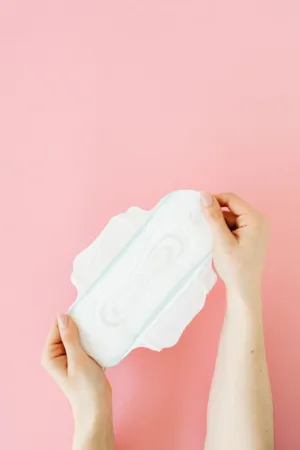 Hands Holding A Sanitary Pad