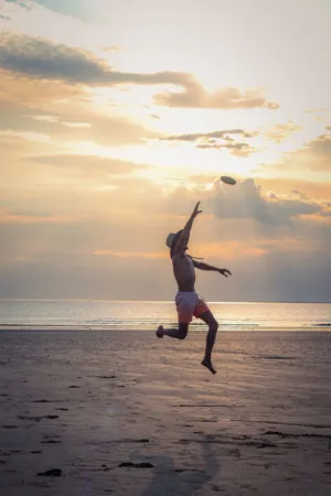 Beach Frisbee At Sunset