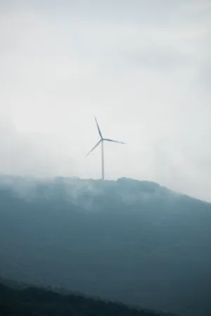 Wind Turbine On A Misty Hill
