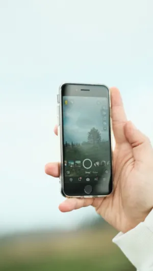 Hand Holding Smartphone With Nature Background