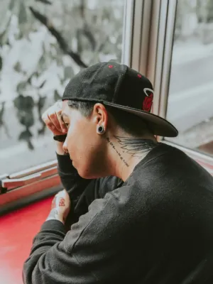 Tattooed Man In Cap