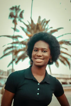 Smiling Woman In Front Of Palm Tree