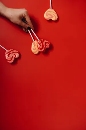 Hand Holding Lollipops