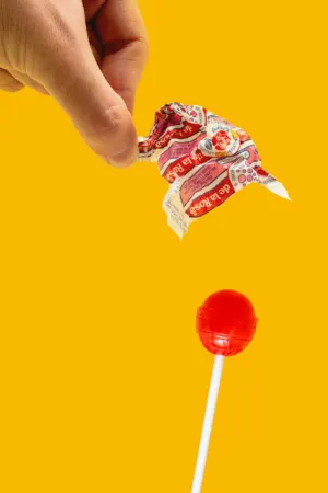 Hand Holding A Lollipop Wrapper