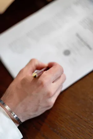 Hand With Pen On Document