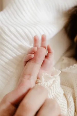Newborn Baby Holding Adult Finger