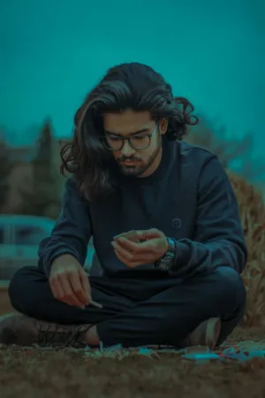 Young Man With Long Hair And Glasses