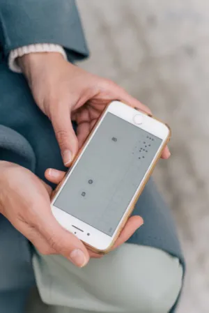 Person Holding Smartphone With App Screen