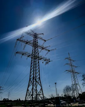 Electricity Pylons And Sunlight