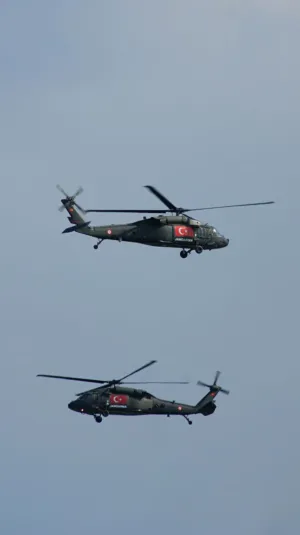 Two Military Helicopters In Flight