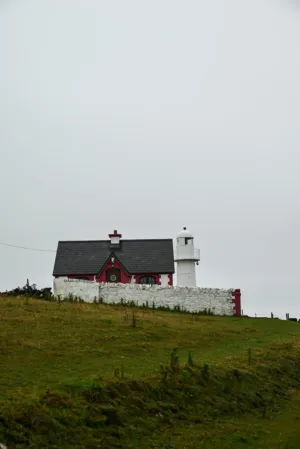 Red And White Cottage With Lighthouse