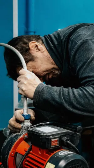 Mechanic Working On Machinery