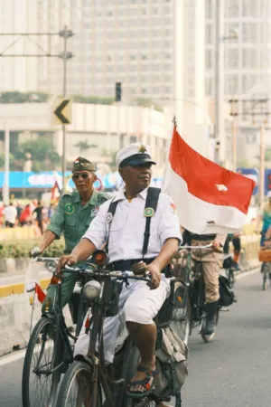 Bicycle Riders With Indonesian Flags