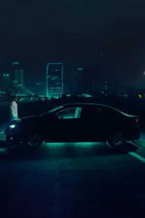 Night Cityscape With Car And Figure