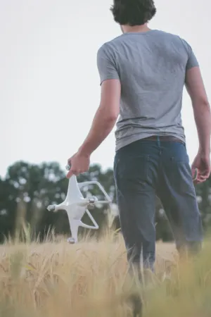 Man With Drone In Field
