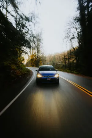 Blue Car On A Forest Road