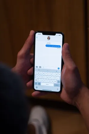 Person Holding Smartphone With Text Message