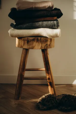 Stack Of Clothes On Wooden Stool