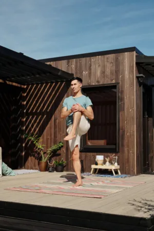 Man Practicing Yoga On Deck