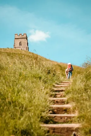 Hiker Climbing Steps To A Tower