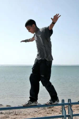 Teenager Balancing On Rail