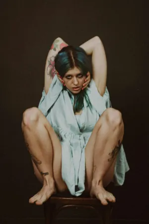Blue-Haired Model With Tattoos