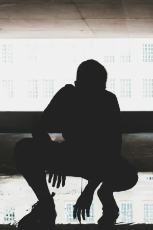 Silhouette Of A Crouching Person