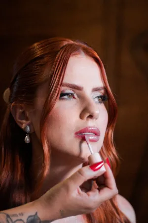Redhead Applying Lip Gloss