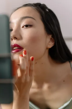 Young Woman Applying Lipstick